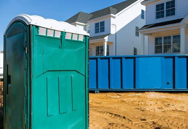 a row of porta potties at a busy work site